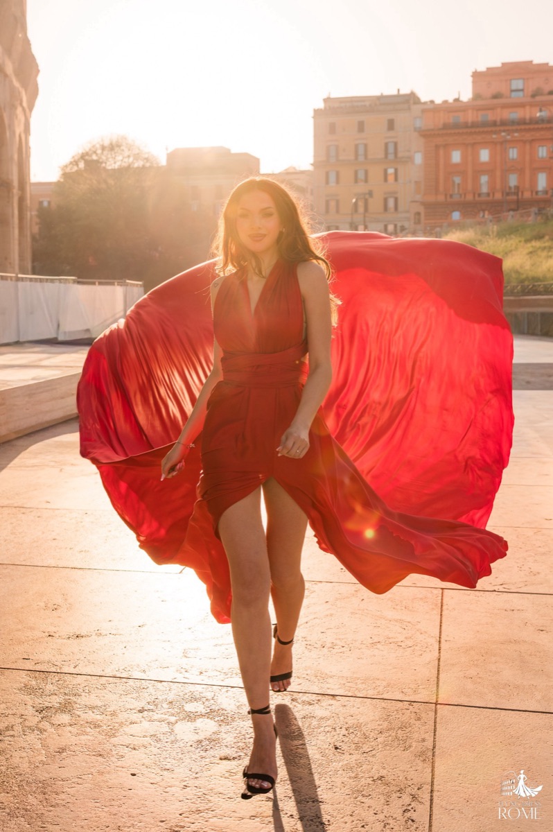 Flying dress pose The Walk: walking into the backlight with the red train opened at both sides, Rome