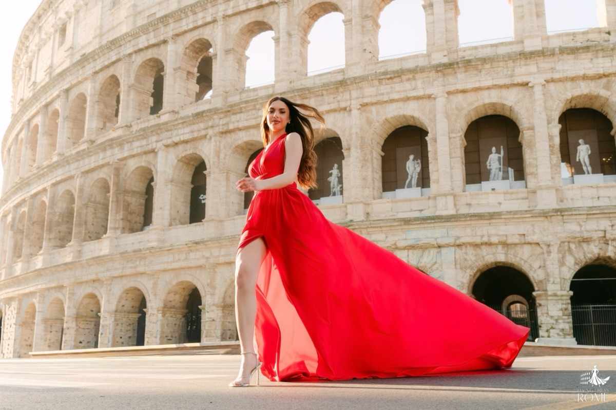 Flying dress pose The Run: a light run with hair in motion and the red skirt wrapping around, Colosseum, Rome
